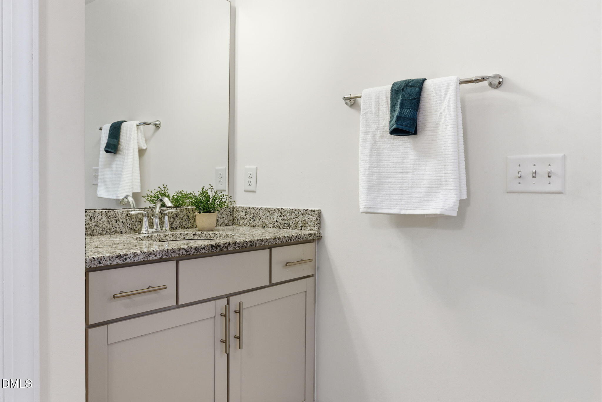 2913 Macbeth Lane Apex, NC 27502 - Photo 45 of 62 a bathroom with a granite countertop sink and a mirror