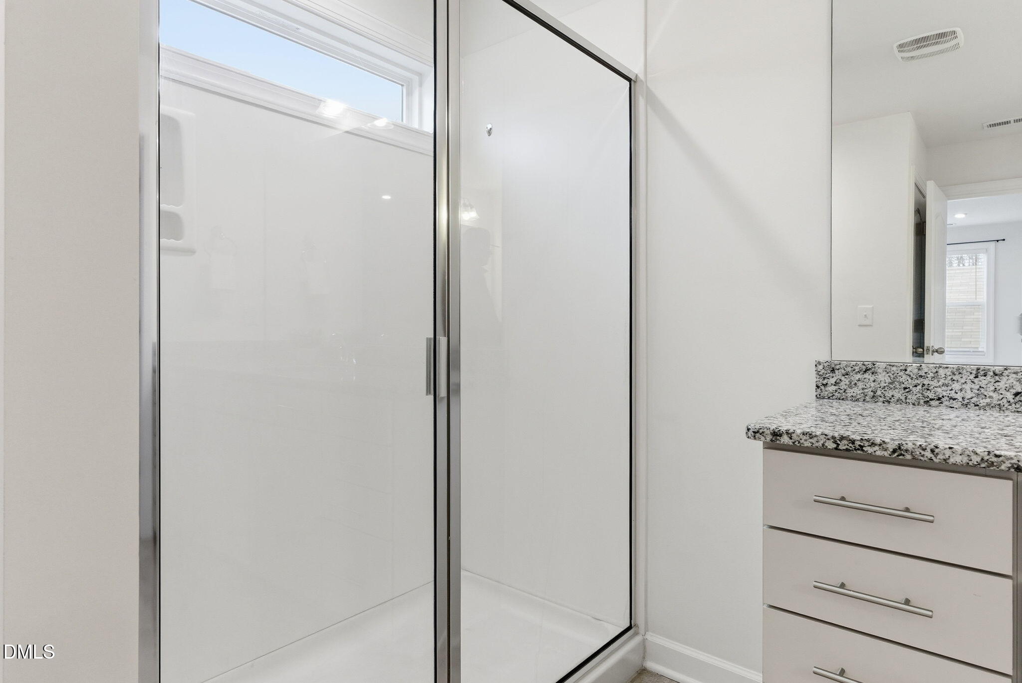 2913 Macbeth Lane Apex, NC 27502 - Photo 48 of 62 a bathroom with a granite countertop sink and a mirror