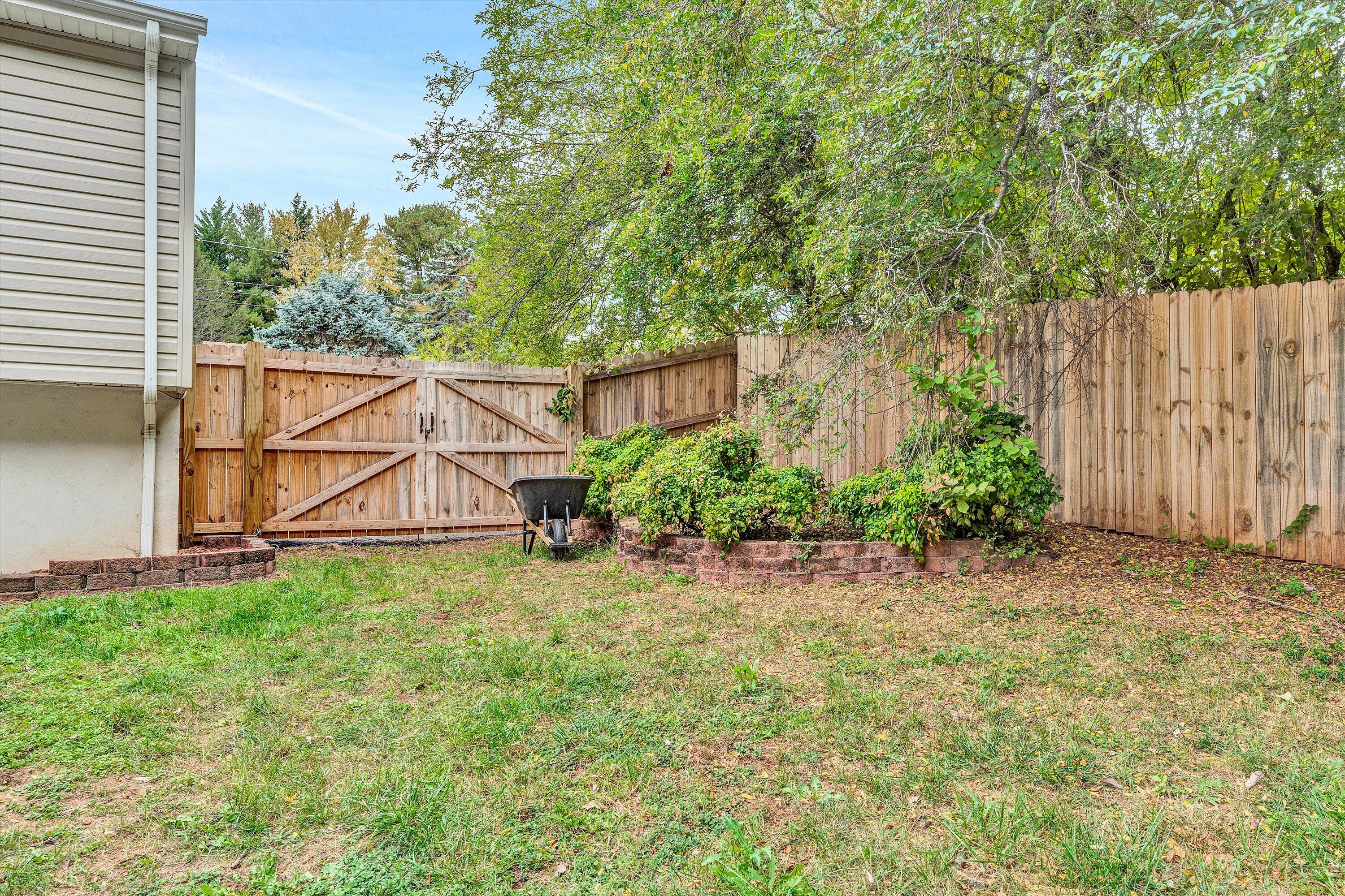 709 Ramada Road Vinton, VA 24179 - Photo 30 of 32 a view of a backyard with plants and a bench