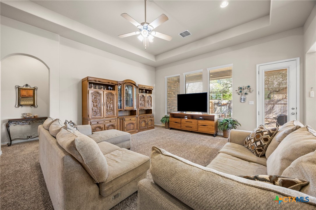1205 Winding Way Drive Georgetown, TX 78628 - Photo 20 of 39 The spacious living room has recessed lighting, ceiling fan, and carpet throughout.