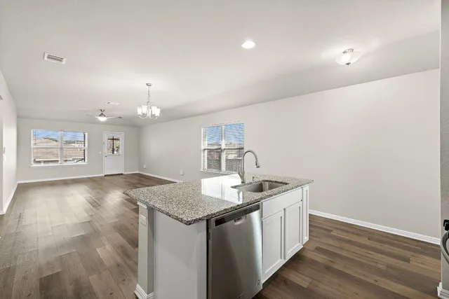 a large kitchen with stainless steel appliances a refrigerator and a stove top oven