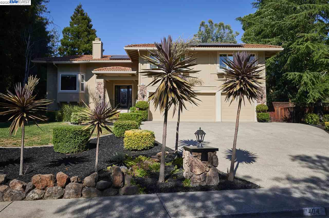a view of a backyard with potted plants and palm trees