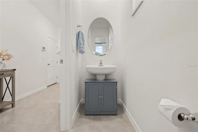 a bathroom with a sink a toilet and mirror