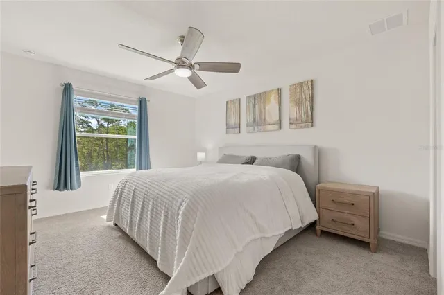 a bedroom with a bed a window and closet