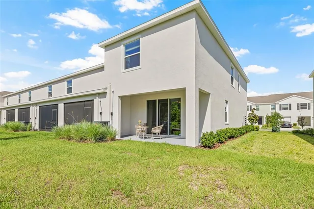 a view of a house with backyard porch and sitting area