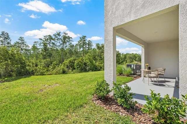 a view of backyard with plants and outdoor seating