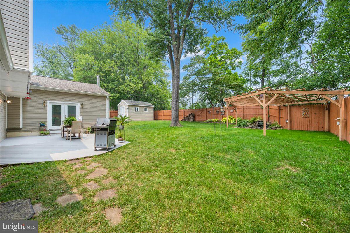 19829 Spurrier Avenue Poolesville, MD 20837 - Photo 40 of 72 Serene backyard oasis with lush greenery.