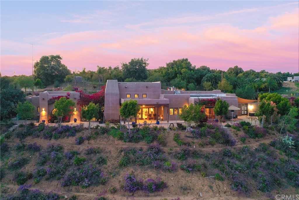 a view of a house with a yard and table and chairs