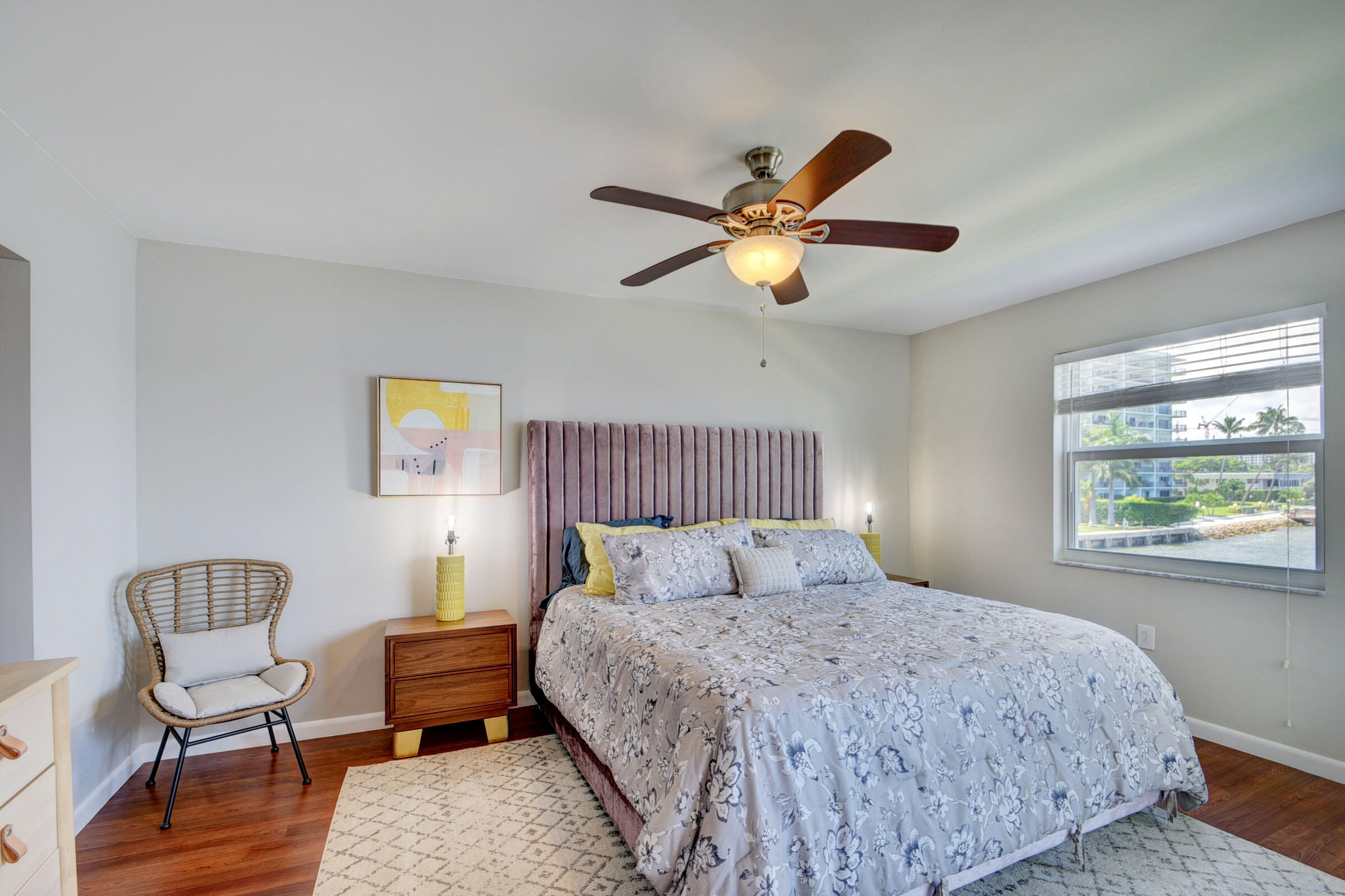 410 Wilma Circle, Unit 204 Riviera Beach, FL 33404 - Photo 15 of 25 a bedroom with a bed a chair and a large window