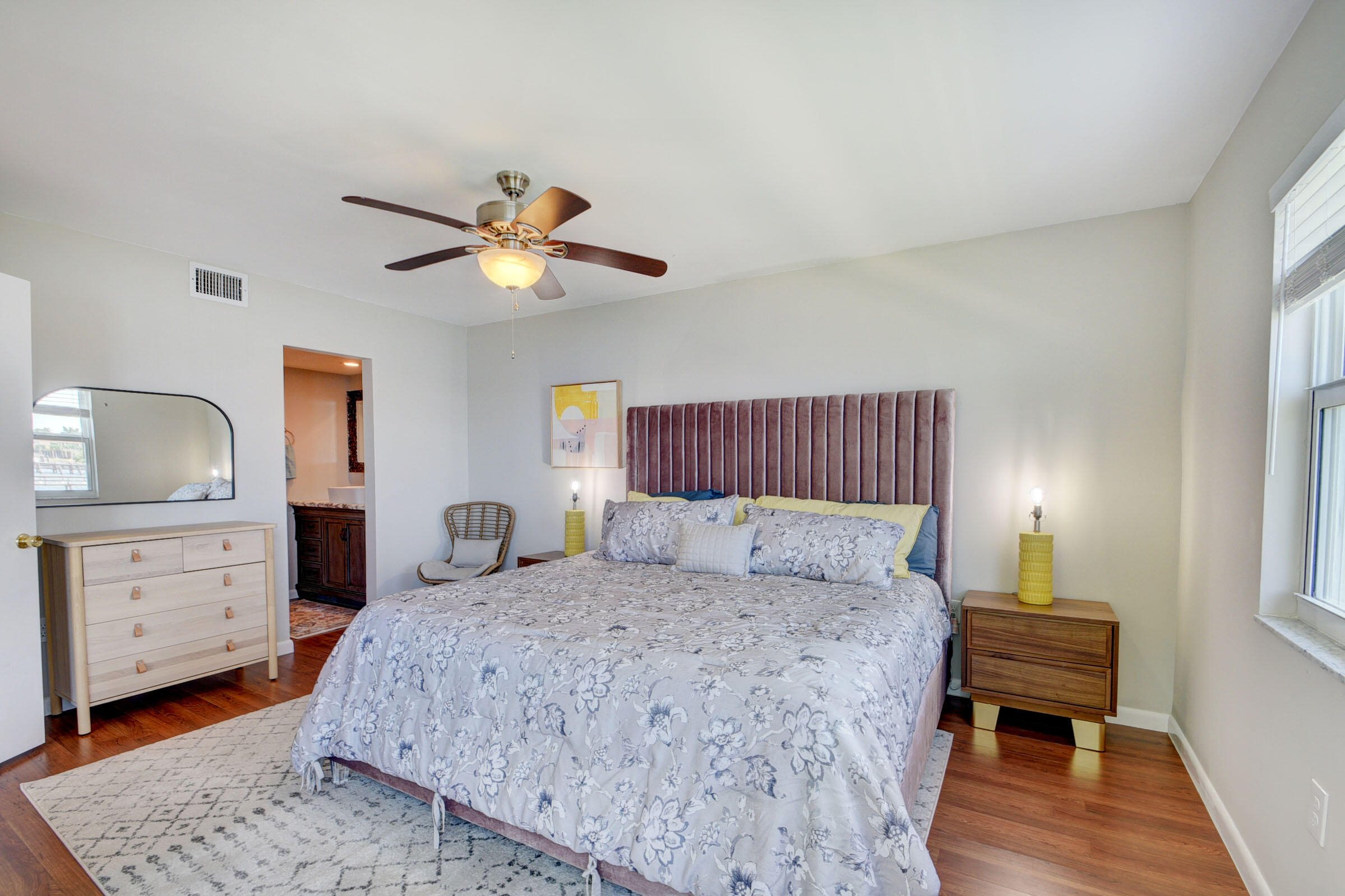 410 Wilma Circle, Unit 204 Riviera Beach, FL 33404 - Photo 16 of 25 a bedroom with a bed and a dresser
