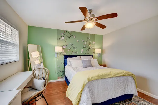 a bedroom with a bed and a chandelier