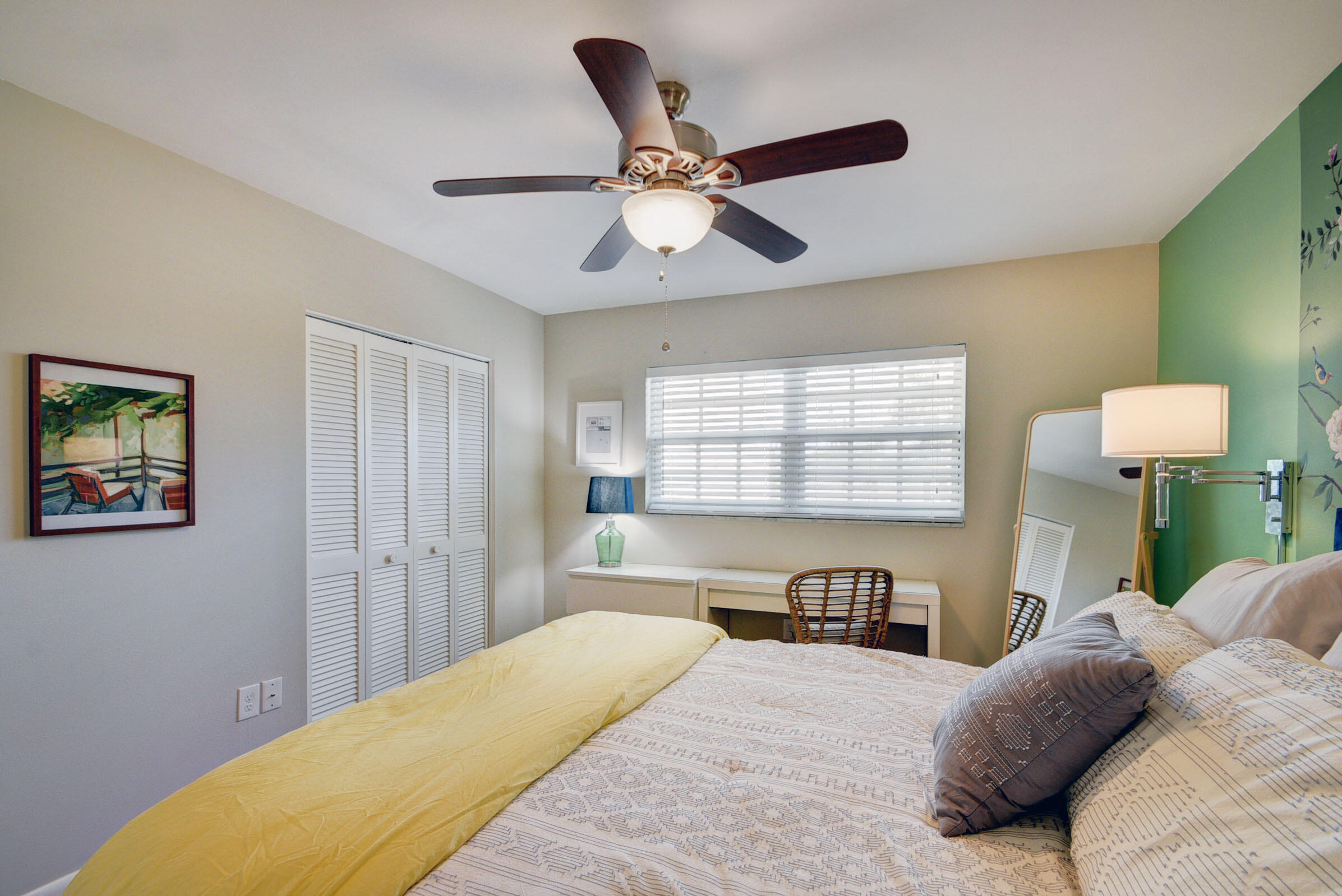 410 Wilma Circle, Unit 204 Riviera Beach, FL 33404 - Photo 22 of 25 a bedroom with a bed and a chandelier