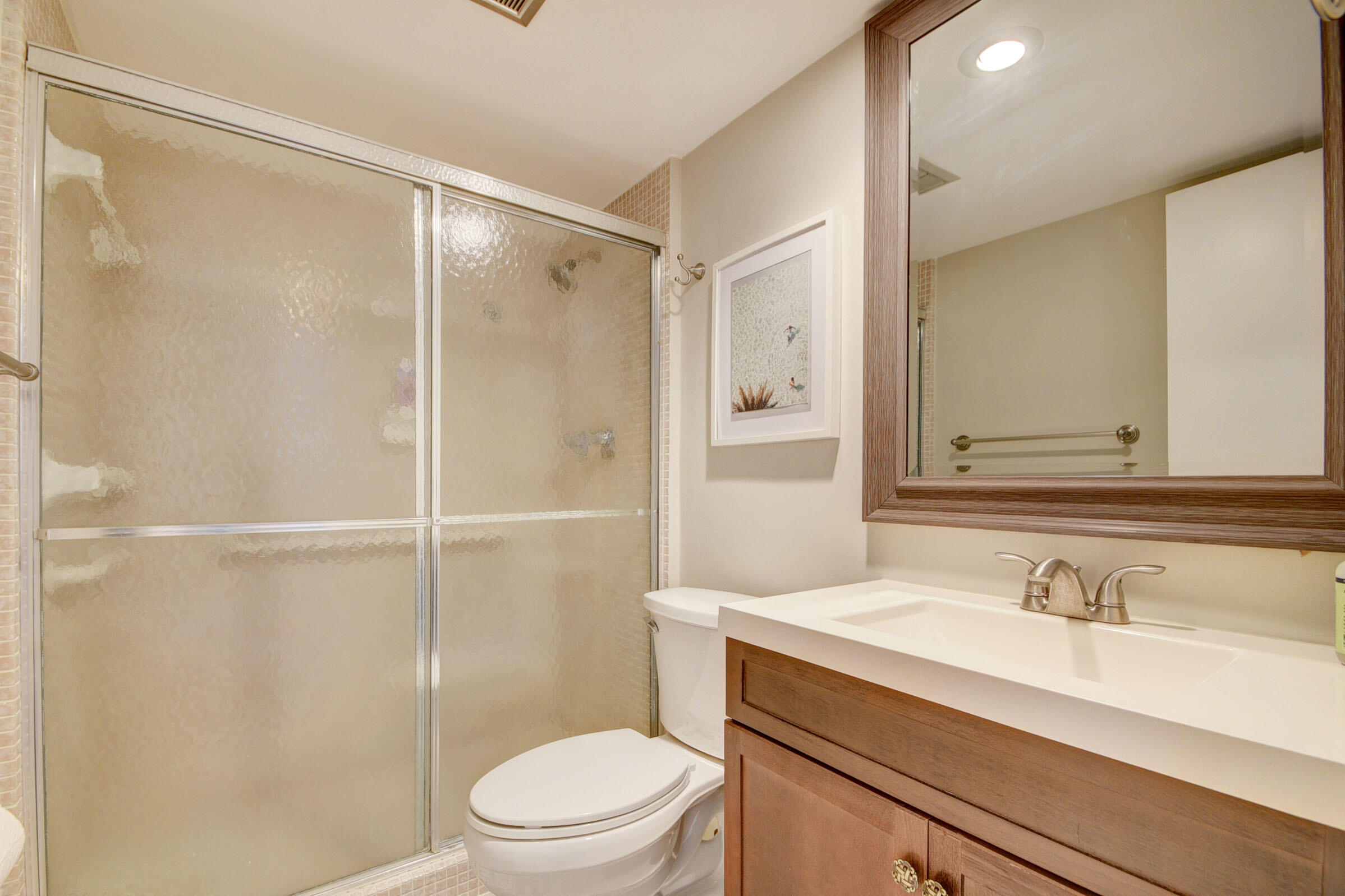 410 Wilma Circle, Unit 204 Riviera Beach, FL 33404 - Photo 23 of 25 a bathroom with a granite countertop sink toilet and shower