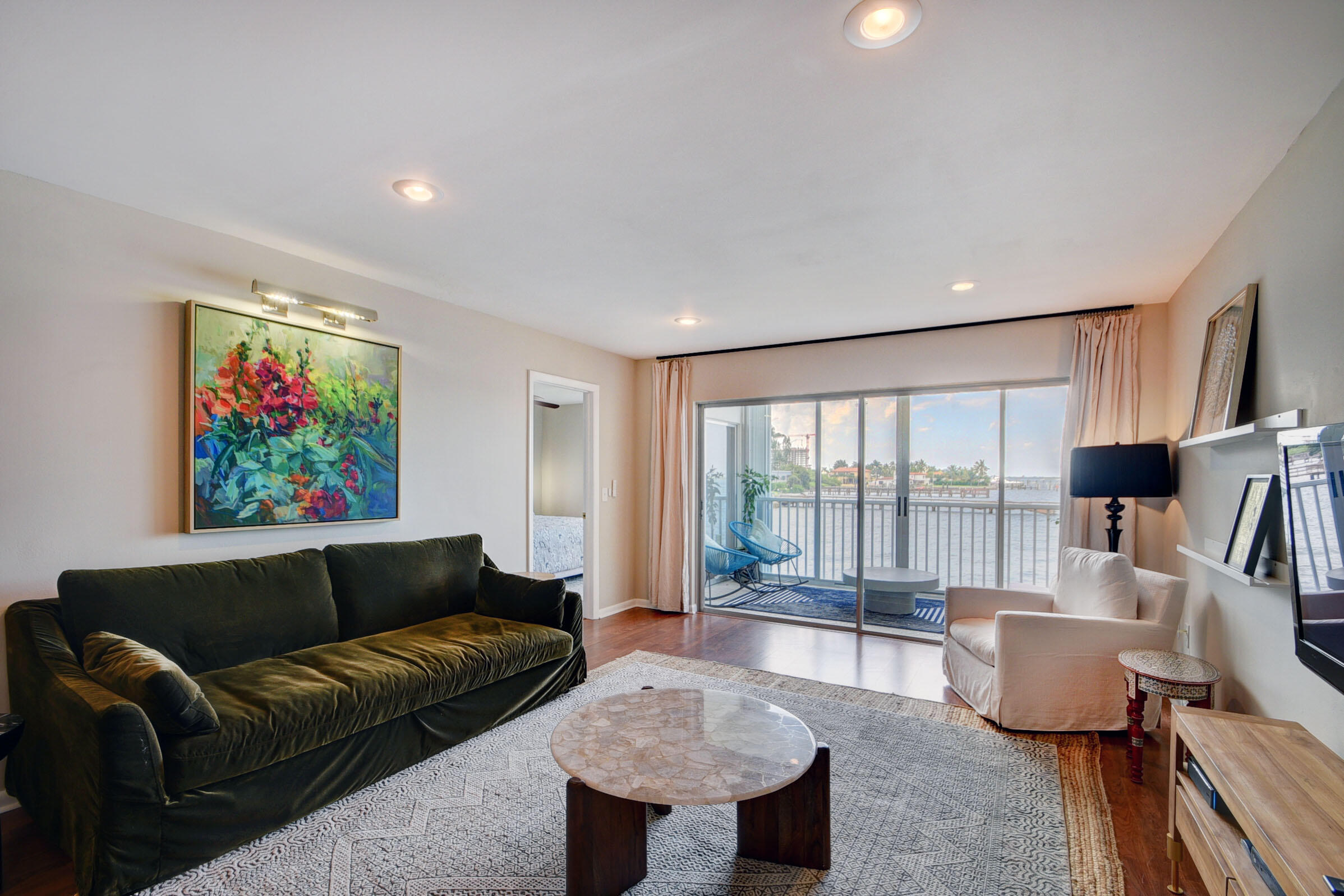 410 Wilma Circle, Unit 204 Riviera Beach, FL 33404 - Photo 9 of 25 a living room with furniture and a large window