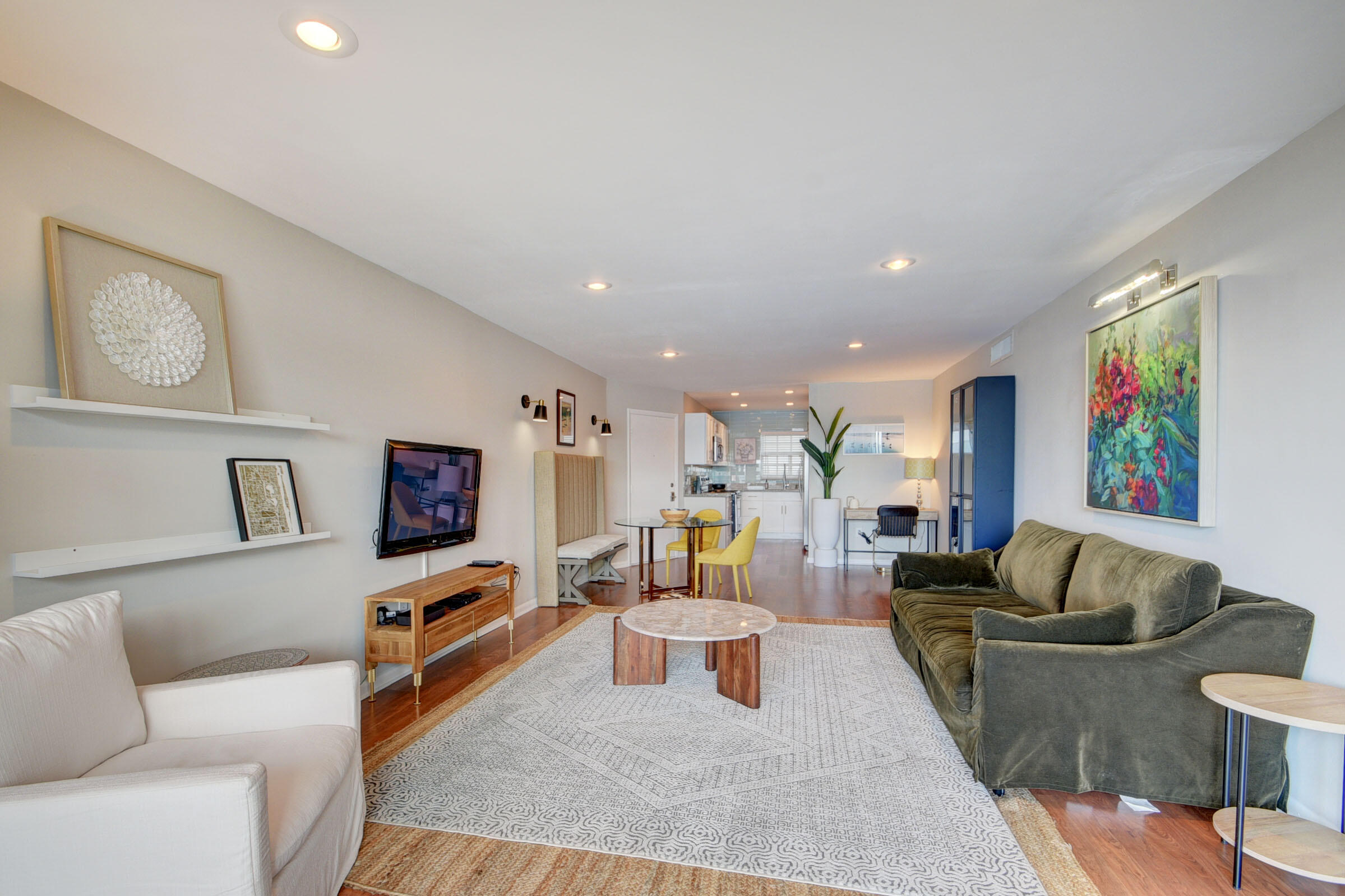 410 Wilma Circle, Unit 204 Riviera Beach, FL 33404 - Photo 10 of 25 a living room with furniture and a flat screen tv