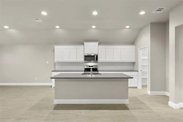 a kitchen that has a sink and a stove