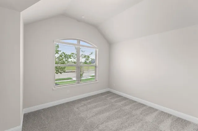 a view of a kitchen with kitchen island white cabinets and stainless steel appliances