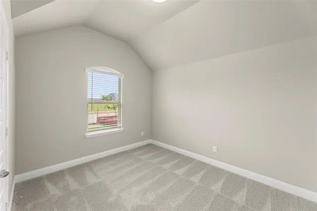a kitchen that has a lot of white cabinets and stainless steel appliances