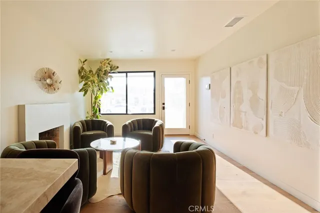 a living room with furniture and two window