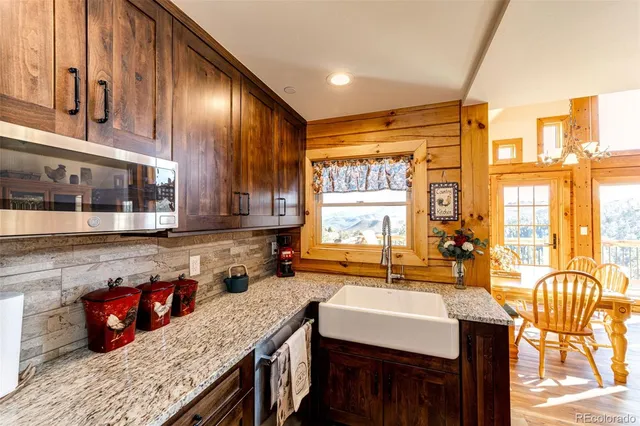 a kitchen with stainless steel appliances granite countertop a sink and a counter space
