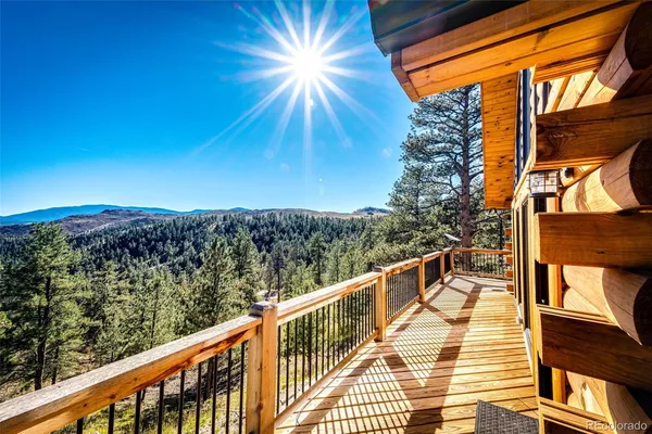 a view of a balcony with wooden floor and fence