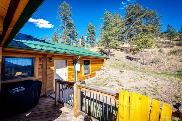 a view of a balcony with two couches and wooden floor