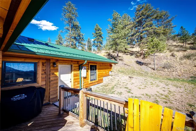 a view of a balcony with two couches and wooden floor