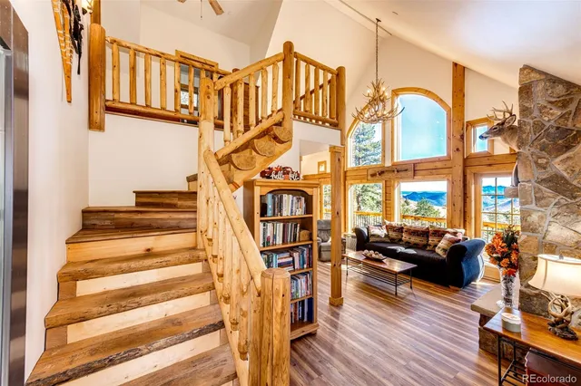 a view of staircase with lots of frames on wall and a wooden floor
