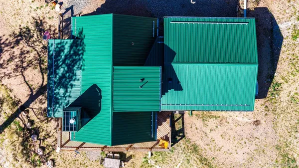 a green field with trees in front of it