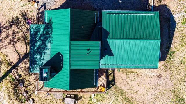 a green field with trees in front of it