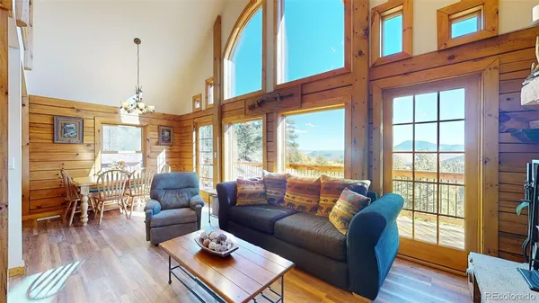 a living room with furniture ceiling fan and a window