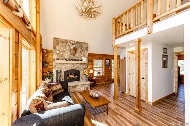 a living room with furniture a fireplace and a window