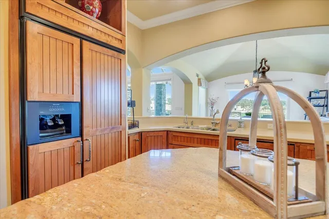 a view of a dining room with furniture a chandelier and wooden floor