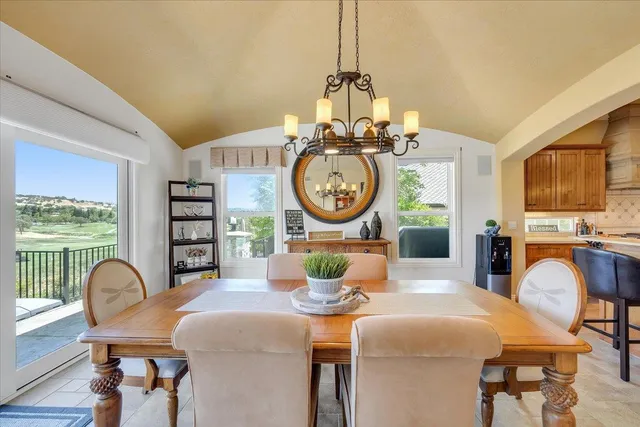 a view of a lake with table and chairs with wooden floor