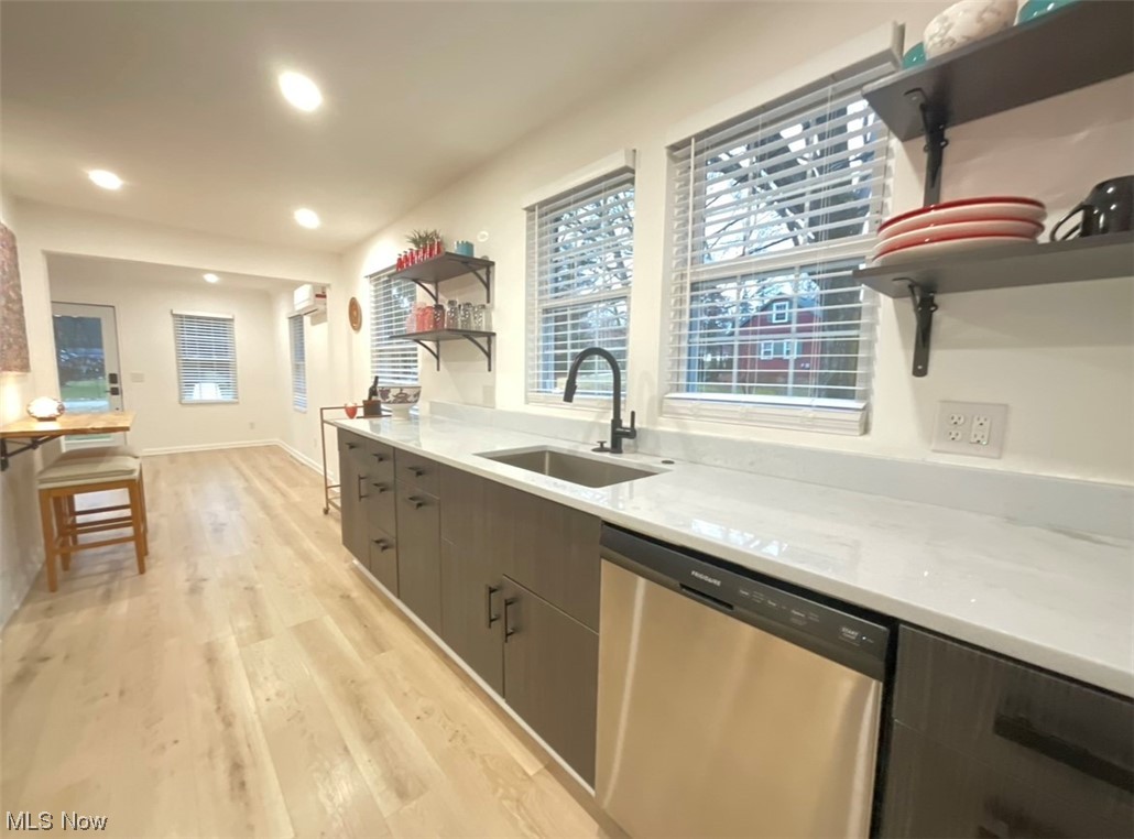 6303 Hillside Road Independence, OH 44131 - Photo 5 of 14 Kitchen featuring light hardwood / wood-style flooring, sink, light stone countertops, and stainless steel dishwasher