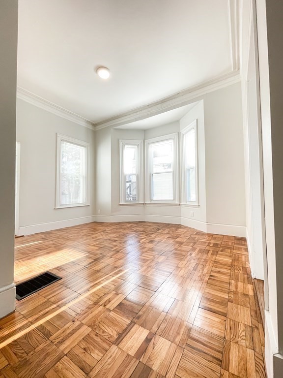 30 Woodbine Street Boston, MA 02119 - Photo 11 of 41 a view of empty room with window and wooden floor