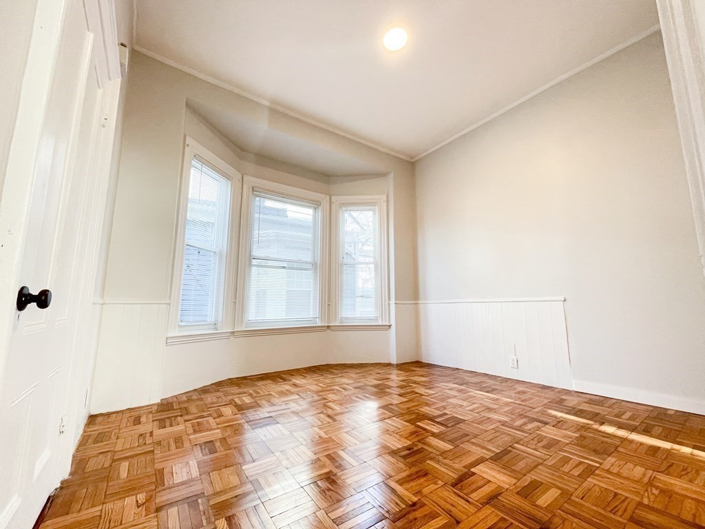 30 Woodbine Street Boston, MA 02119 - Photo 15 of 41 a view of empty room with wooden floor and fan