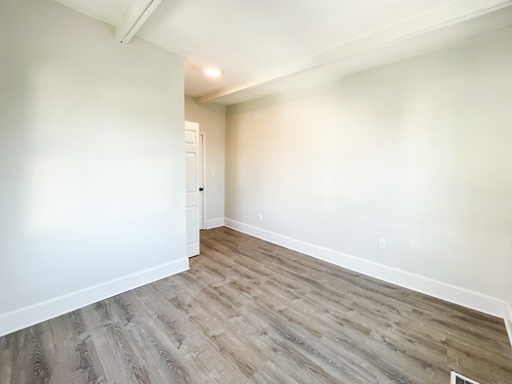30 Woodbine Street Boston, MA 02119 - Photo 24 of 41 a view of an empty room with wooden floor