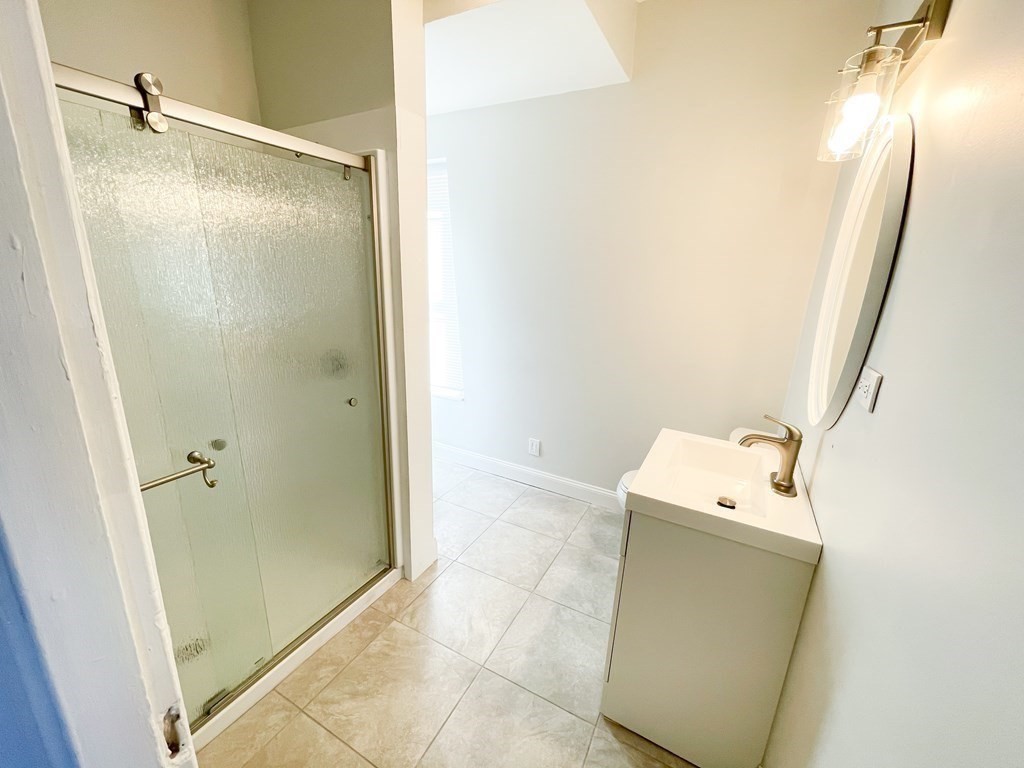 30 Woodbine Street Boston, MA 02119 - Photo 28 of 41 a bathroom with a shower and a toilet