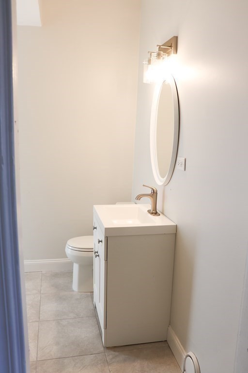 30 Woodbine Street Boston, MA 02119 - Photo 31 of 41 a utility room with a sink a toilet and a mirror