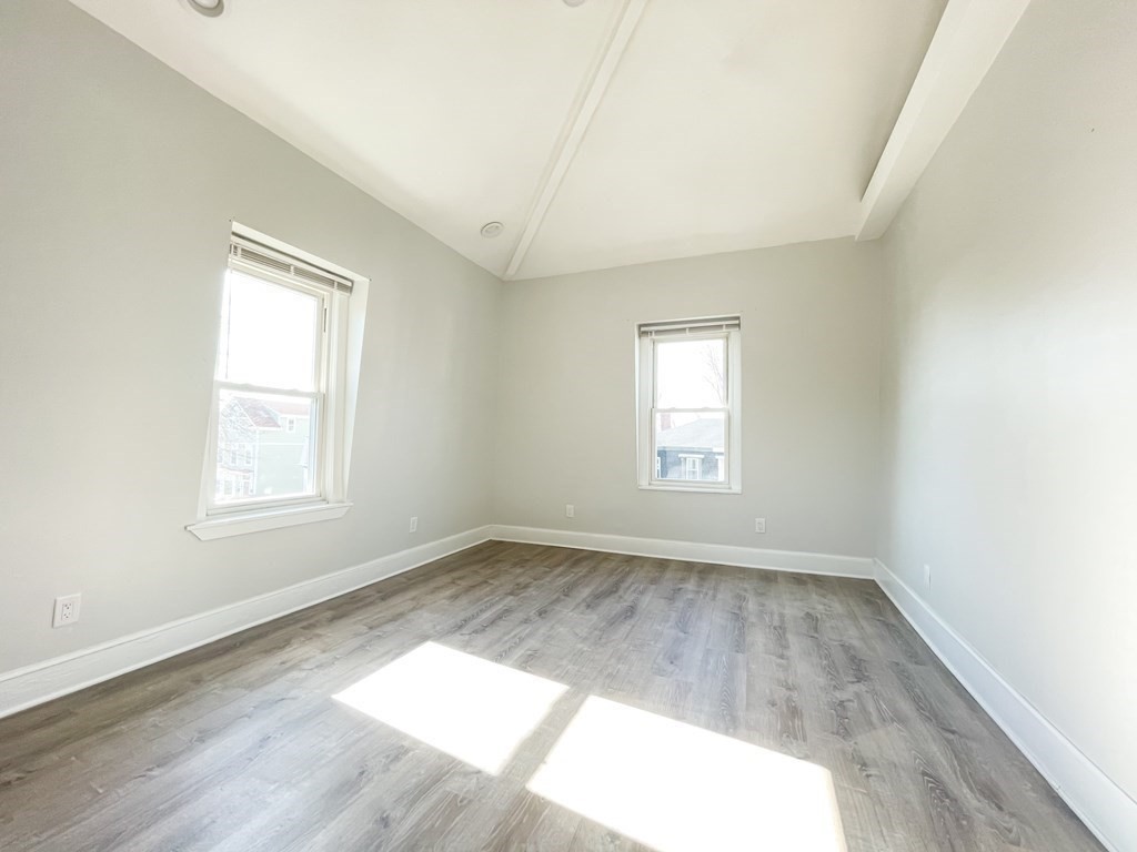 30 Woodbine Street Boston, MA 02119 - Photo 34 of 41 an empty room with wooden floor and windows