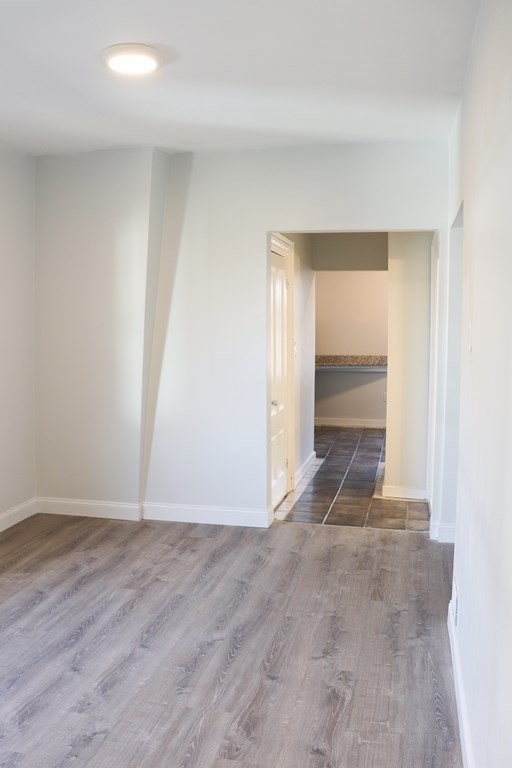 30 Woodbine Street Boston, MA 02119 - Photo 36 of 41 an empty room with wooden floor and entrance