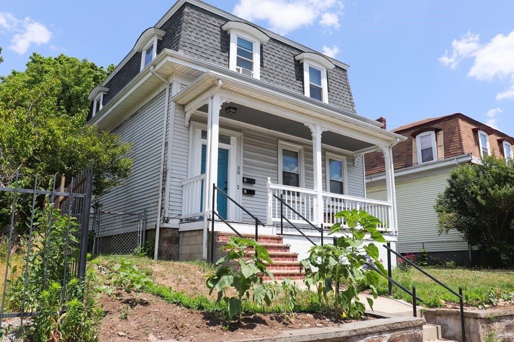 30 Woodbine Street Boston, MA 02119 - Photo 39 of 41 a front view of a house with a garden