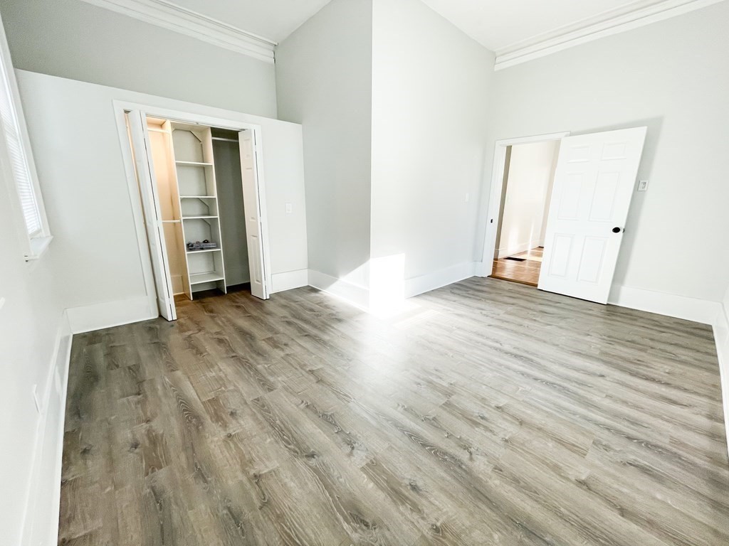 30 Woodbine Street Boston, MA 02119 - Photo 9 of 41 an empty room with wooden floor and windows