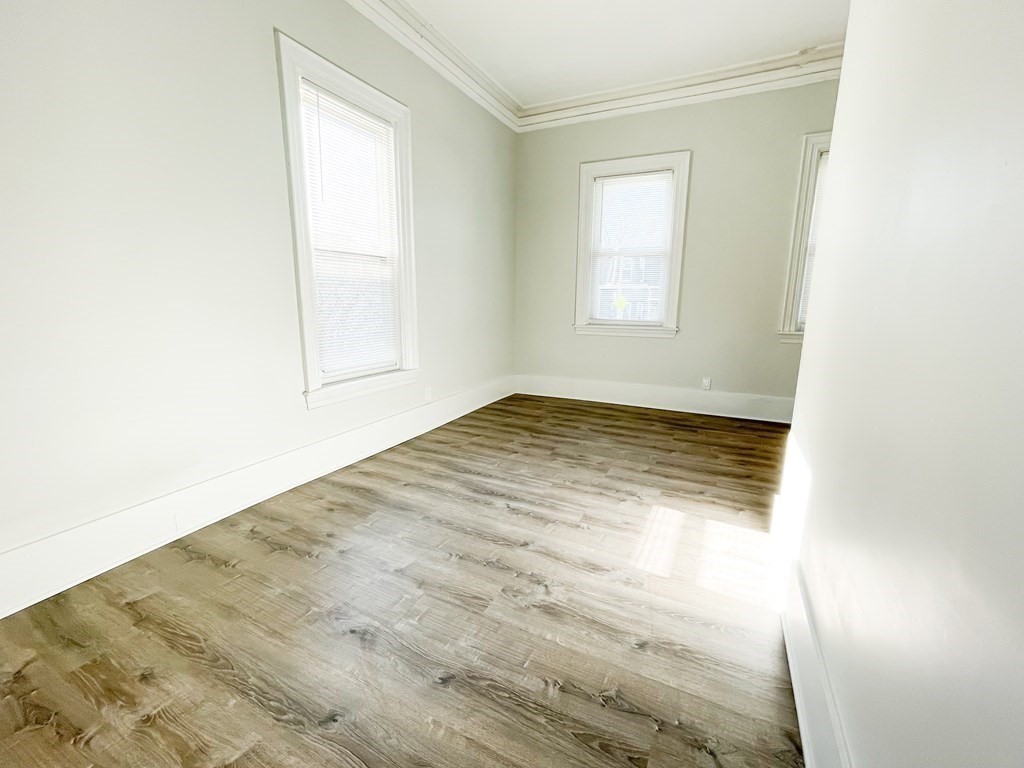 30 Woodbine Street Boston, MA 02119 - Photo 10 of 41 an empty room with wooden floor and windows