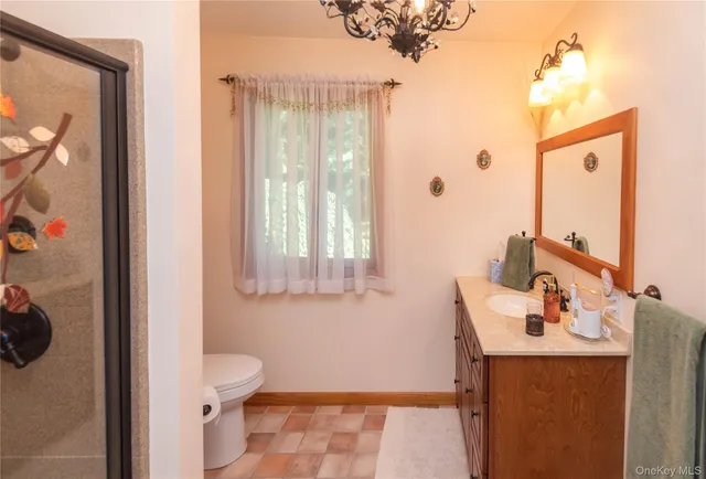 a bathroom with a sink a toilet and shower curtain