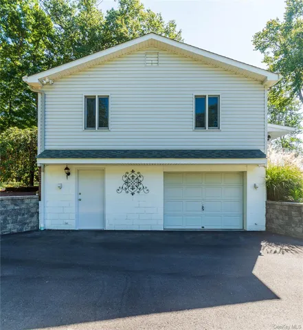 a view of a wooden door and a yard