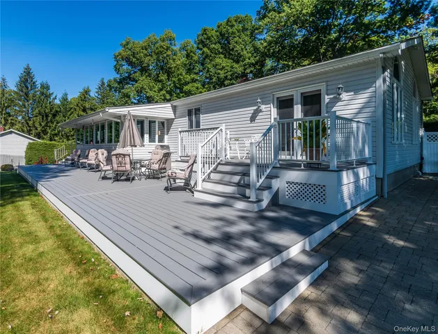 a view of a house with backyard and sitting area