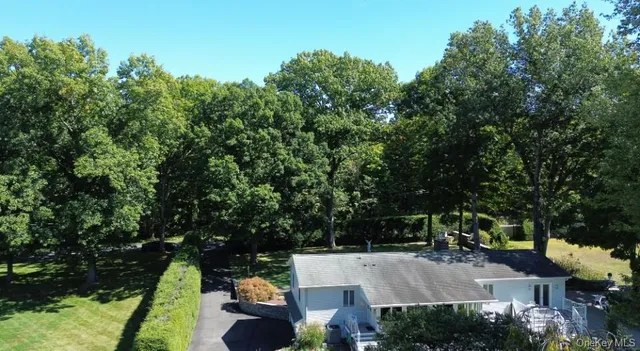 an aerial view of a house with swimming pool and garden
