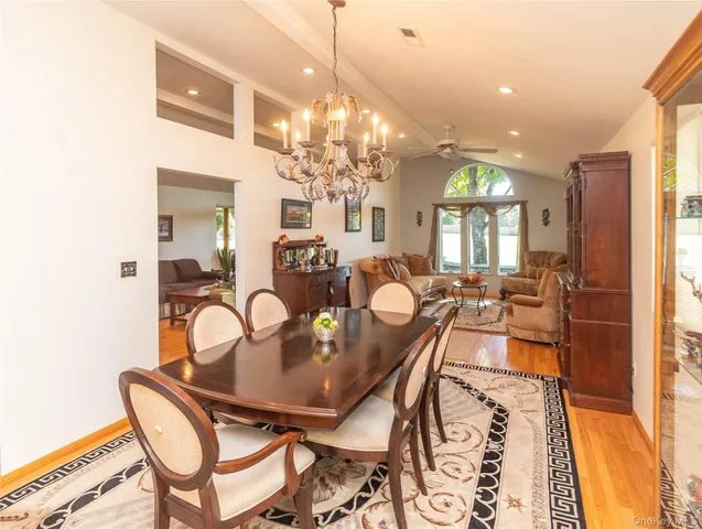 a view of a dining room with furniture and a chandelier